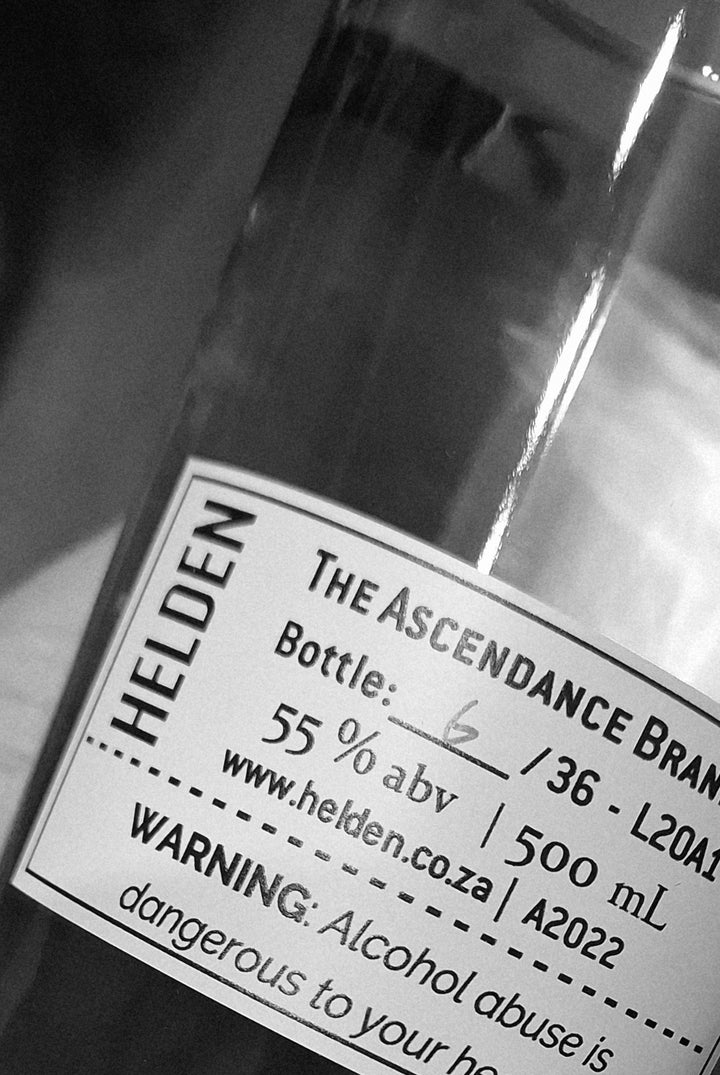 Close-up of a bottle label with 'HELDEN' branding and product details.