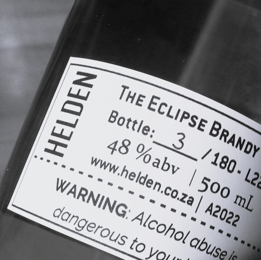 Close-up of a dark bottle label reading &