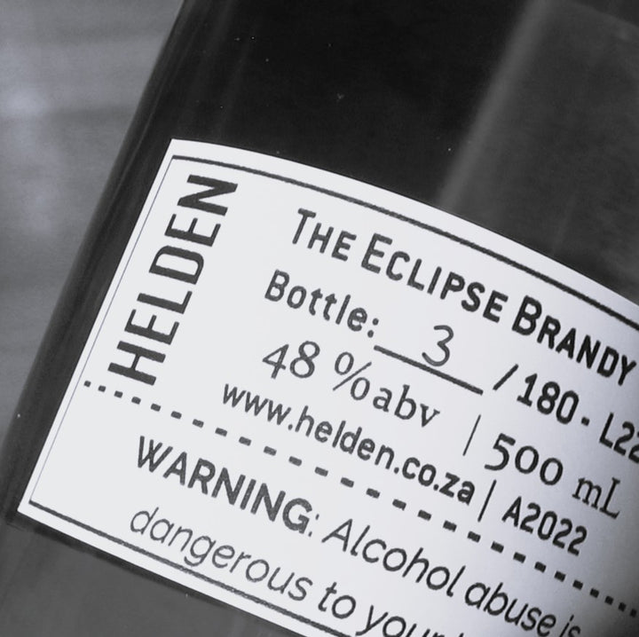 Close-up of a dark bottle label reading &
